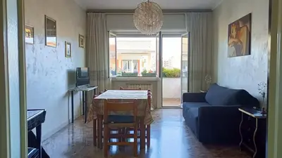 a living room with a blue couch and a table at A casa di Ugo - Colors and space at Pigneto, Rome in Rome
