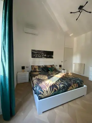 a bedroom with a bed in a white room at Bart Rome House in Rome