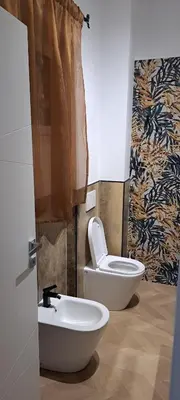 a bathroom with a toilet and a sink at Bart Rome House in Rome