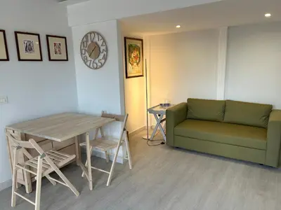 a living room with a couch and a table at Primavalle Lodge - METRO Battistini in Rome