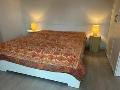 a bedroom with a bed with two lamps on two tables at Primavalle Lodge - METRO Battistini in Rome