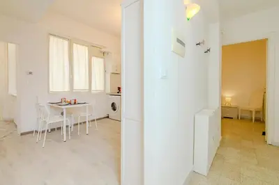 a kitchen and dining room with a table and chairs at Operetta View Apartment in Rome