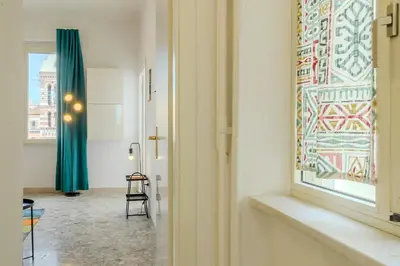 a room with a window and a table and a chair at Operetta View Apartment in Rome