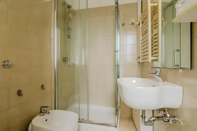 a bathroom with a sink and a shower and a toilet at Operetta View Apartment in Rome