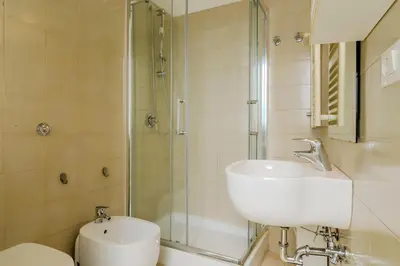 a bathroom with a shower and a sink and a toilet at Operetta View Apartment in Rome
