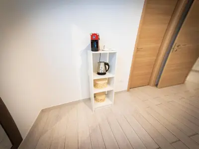 a room with a white shelf with a coffee pot on it at La Stella di Roma al Vaticano in Rome