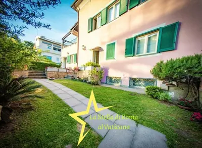a star in the grass in front of a house at La Stella di Roma al Vaticano in Rome