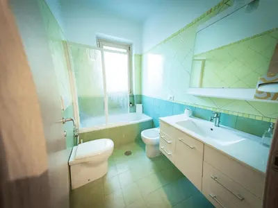 a bathroom with a sink and a toilet and a mirror at La Stella di Roma al Vaticano in Rome