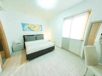 a bedroom with a bed and a large window at La Stella di Roma al Vaticano in Rome
