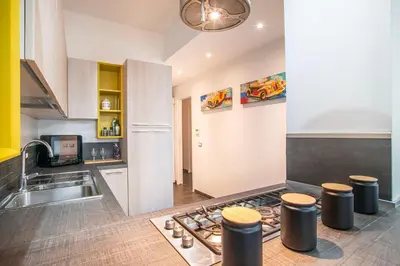 a kitchen with a stove top oven next to a sink at Battistini Pretty Apartment in Rome