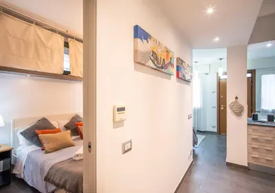 a small bedroom with a bed and a bathroom at Battistini Pretty Apartment in Rome