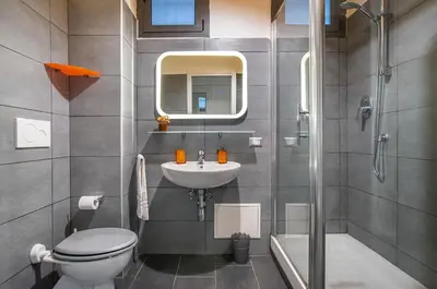 a bathroom with a sink and a toilet and a shower at Battistini Pretty Apartment in Rome
