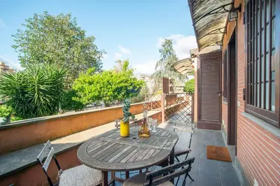 a patio with a table and chairs on a balcony at Battistini Pretty Apartment in Rome