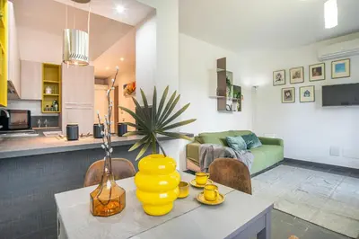 a living room with a table with a yellow vase on it at Battistini Pretty Apartment in Rome