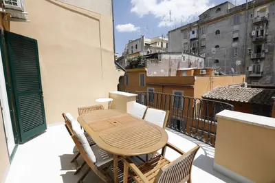a table and chairs on the balcony of a building at Colosseum Panoramic Terrace in Rome