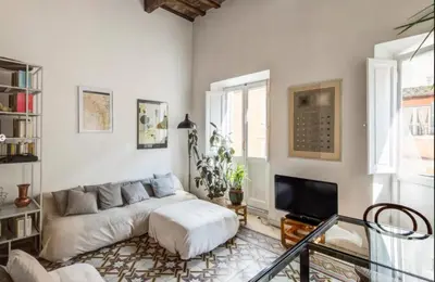 a living room with a couch and a tv at Colosseum Panoramic Terrace in Rome