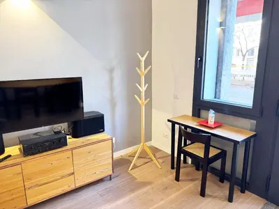 a living room with a table and a tv at Urban Loft 55 in Rome