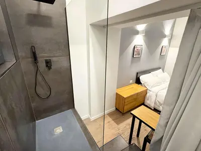 a small bathroom with a shower and a bed at Urban Loft 55 in Rome