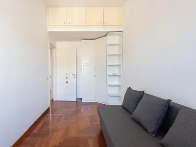 a living room with a couch and a closet at Vittorio Panoramic Apartment in Rome