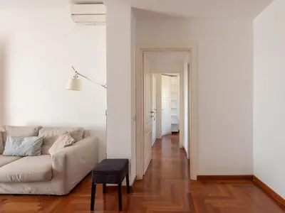 a white living room with a couch and a table at Vittorio Panoramic Apartment in Rome