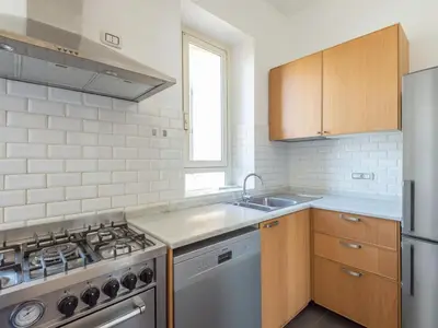 a kitchen with a stove and a sink at Vittorio Panoramic Apartment in Rome