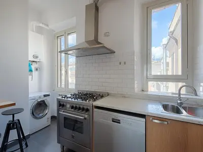 a kitchen with a stove top oven next to a window at Vittorio Panoramic Apartment in Rome