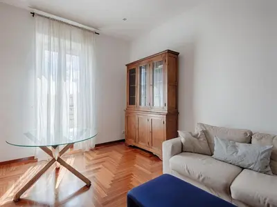 a living room with a couch and a glass table at Vittorio Panoramic Apartment in Rome