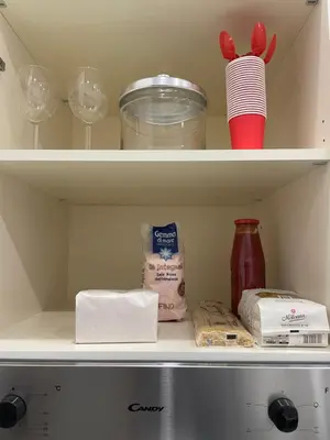 a refrigerator shelf with food and other items in it at Residenza Tulipano in Rome