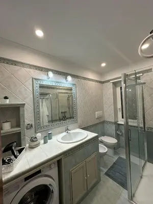 a bathroom with a sink and a washing machine at Residenza Tulipano in Rome