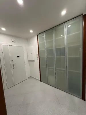 an empty hallway with glass doors in a building at Residenza Tulipano in Rome