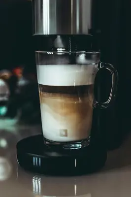 a cup of coffee sitting on top of a blender at Vatican deluxe apartment - Casa Cesarina in Rome