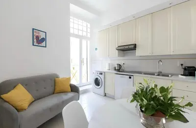 a living room with a couch and a kitchen at Vatican deluxe apartment - Casa Cesarina in Rome