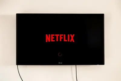 a television with the words netflix on the screen at Vatican deluxe apartment - Casa Cesarina in Rome
