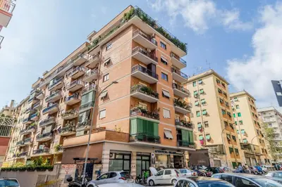 a tall building with cars parked in front of it at Casa da Annarella in Rome