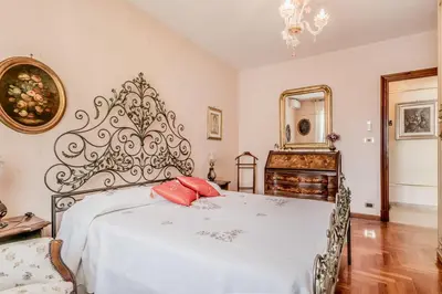 a bedroom with a white bed with red pillows on it at Casa da Annarella in Rome