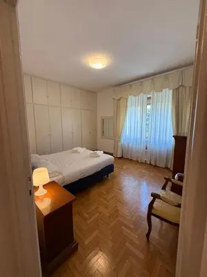 a bedroom with a bed and a table and a chair at St Peter Rooms with Private Parking by Dama in Rome