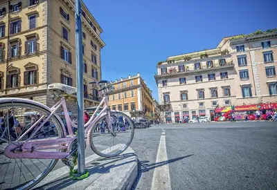 a pink bike parked on the side of a street at Little Queen Relais in Rome