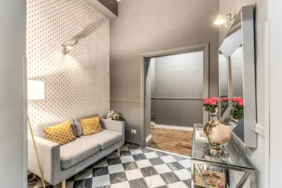 a living room with a couch and a mirror at Little Queen Relais in Rome