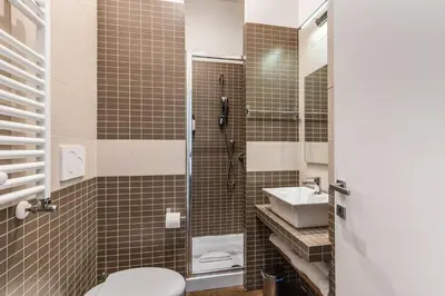 a bathroom with a toilet and a sink at Little Queen Relais in Rome