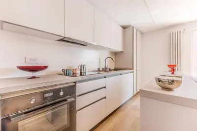 a kitchen with white cabinets and a bowl on the counter at APT ROME Sergio I - San Pietro Vatican in Rome