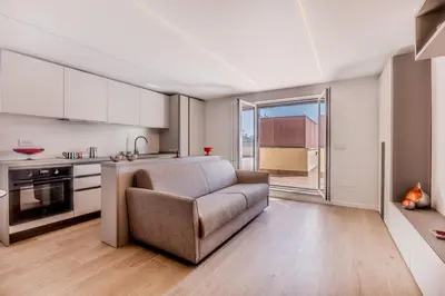 a living room with a couch and a kitchen at APT ROME Sergio I - San Pietro Vatican in Rome