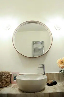 a bathroom sink with a large mirror on the wall at Flowers Rooms - Ponte Milvio in Rome