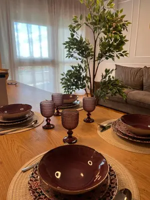 a wooden table with plates and bowls on top of it at Luxury House Alessia in Rome