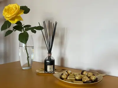 a table with a bottle of wine and a plate of food at Luxury House Alessia in Rome
