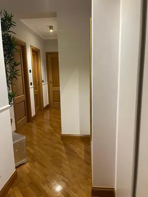 an empty hallway with white walls and wooden floors at Luxury House Alessia in Rome
