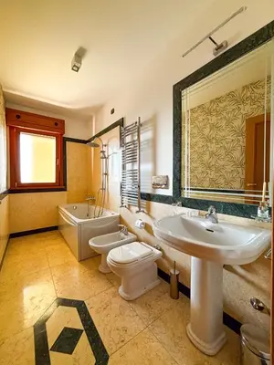 a bathroom with a sink and a toilet and a tub at Luxury House Alessia in Rome
