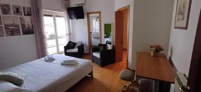 a bedroom with a bed and a living room at Lively House in Rome