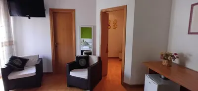 a living room with two chairs and a mirror at Lively House in Rome
