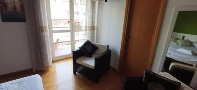 a room with a chair and a bed and a window at Lively House in Rome