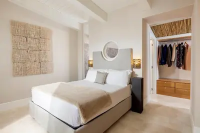 a white bedroom with a bed and a mirror at Dimora della Luna in Rome